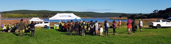 A large group of people standing in a field

Description automatically generated with low confidence