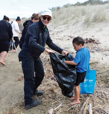 A person and child picking up trash

Description automatically generated with medium confidence