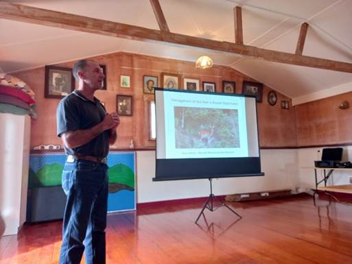 A person standing in front of a television

Description automatically generated with medium confidence