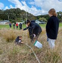 A group of people in a field

Description automatically generated