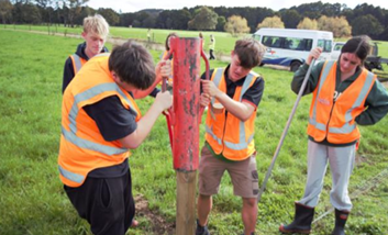 A group of men in orange vests

Description automatically generated