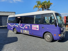 A purple and white bus

Description automatically generated