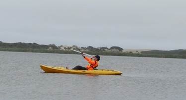 A person in a kayak on the water

Description automatically generated
