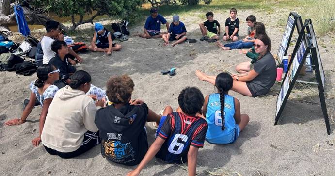 A group of people sitting in a circle

Description automatically generated