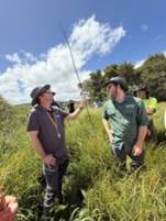 A group of men in a field
Description automatically generated