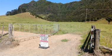 A fenced in area with a sign

AI-generated content may be incorrect.